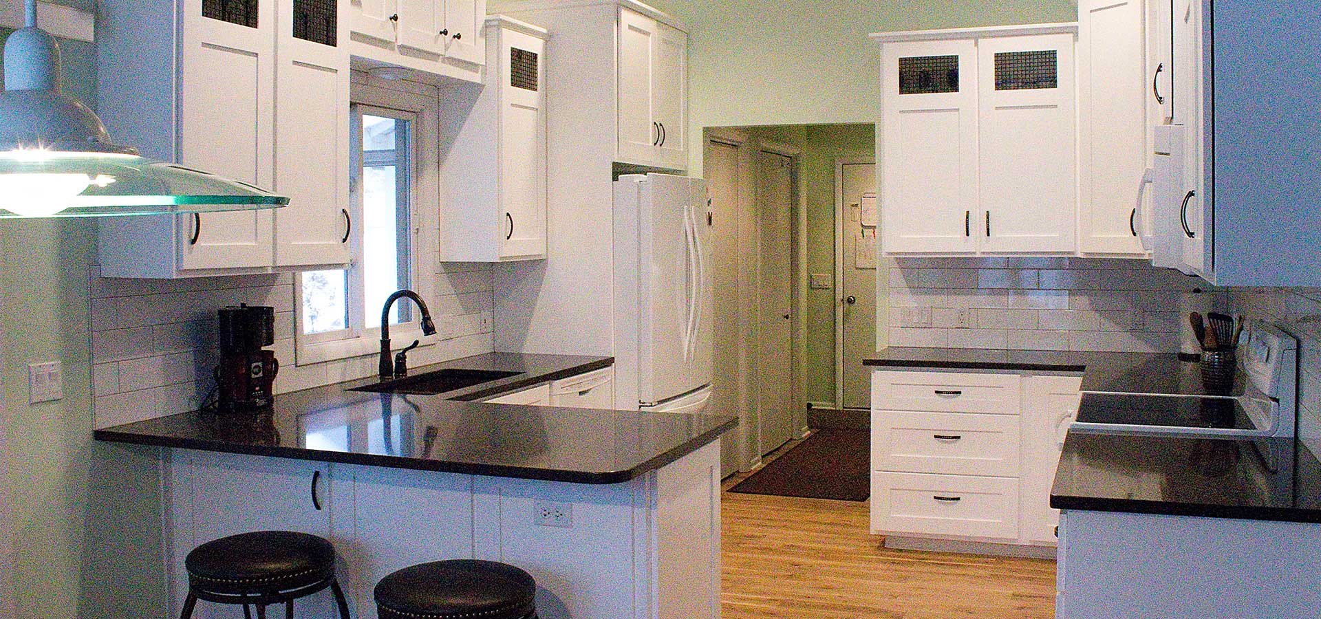 Custom white kitchen with black countertops